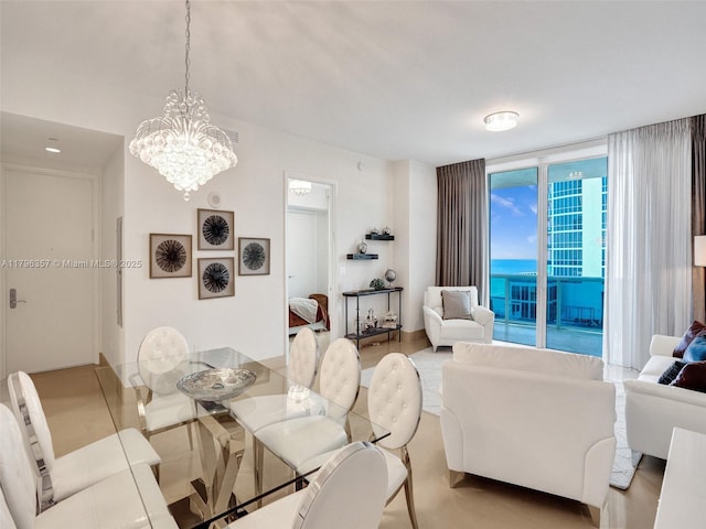 dining area with a chandelier and expansive windows