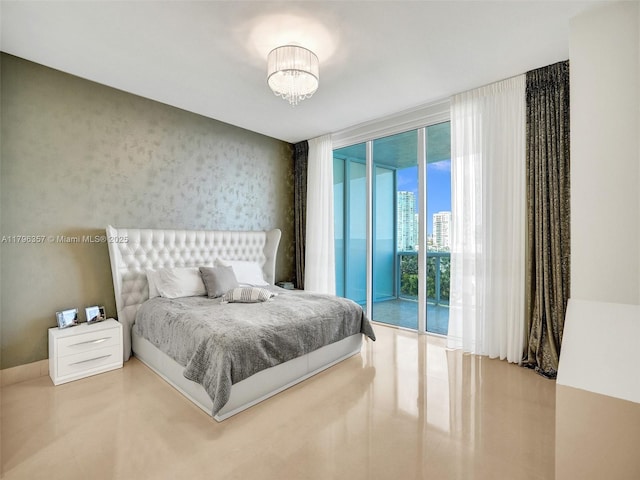 bedroom featuring access to exterior, a wall of windows, and a chandelier