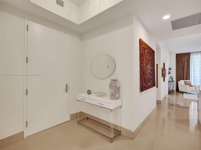 hall with recessed lighting and baseboards