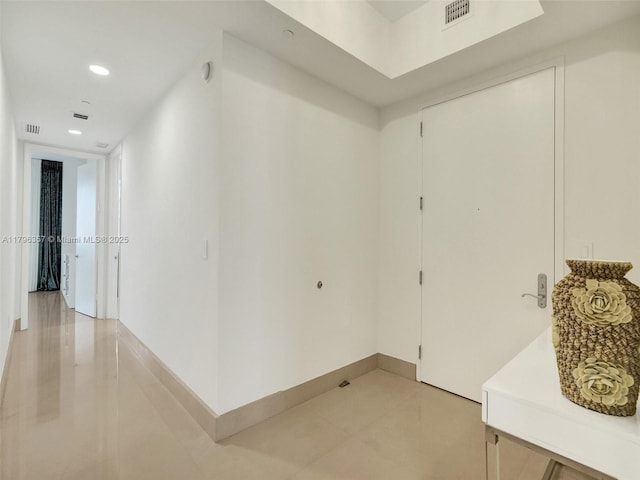 corridor with light tile patterned floors, recessed lighting, and baseboards