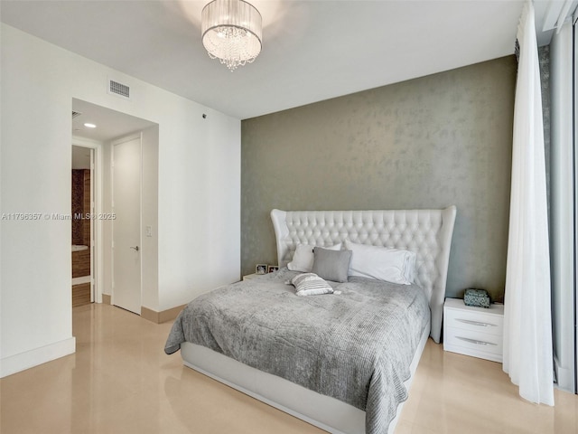 bedroom featuring a chandelier and baseboards