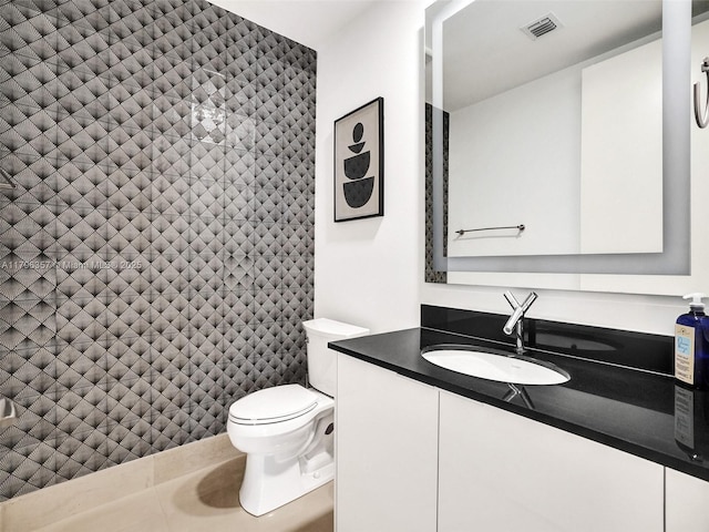 bathroom featuring toilet and vanity