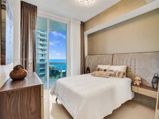 bedroom featuring access to outside, a water view, and tile patterned flooring