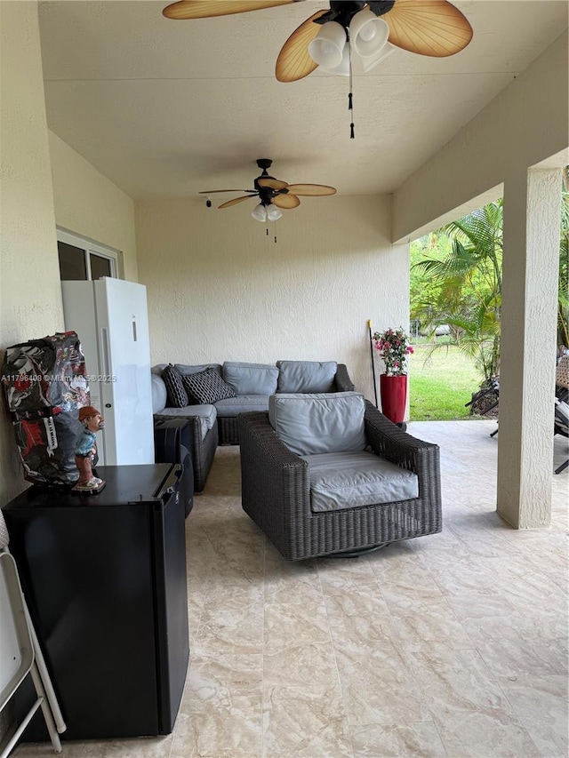 view of patio / terrace with ceiling fan and an outdoor living space