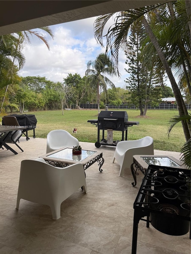 view of patio with fence and a grill