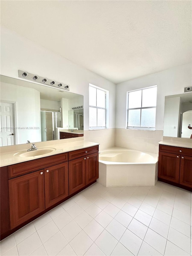 full bathroom with vanity, tile patterned floors, a garden tub, and a stall shower
