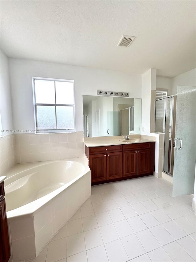 full bathroom featuring visible vents, a shower stall, a garden tub, and vanity