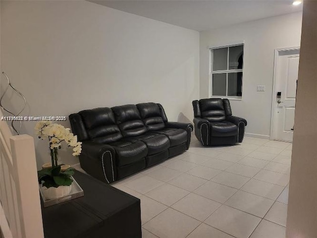 living room with light tile patterned floors and baseboards