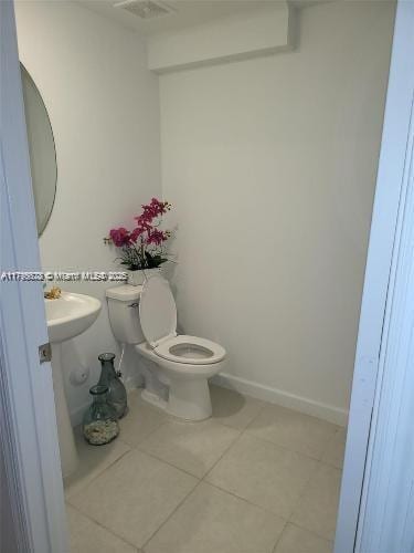 bathroom featuring toilet, visible vents, and tile patterned flooring