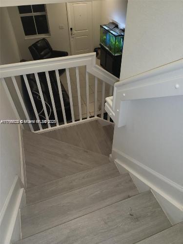 stairway featuring wood finished floors