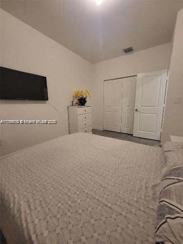 bedroom with visible vents and a closet