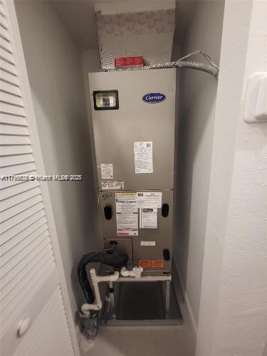 utility room with heating unit