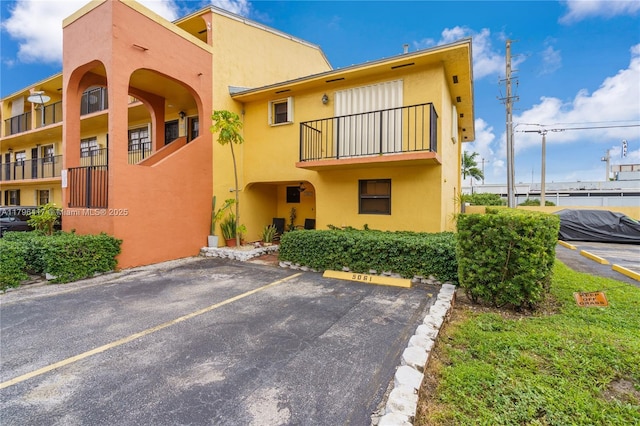 5061 W 12th Ln Unit E-10, Hialeah, FL 33012 - view of building exterior with uncovered parking