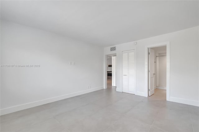 240 Galen Dr Unit 308, Key Biscayne, FL 33149 - unfurnished bedroom featuring baseboards, a closet, visible vents, and concrete floors