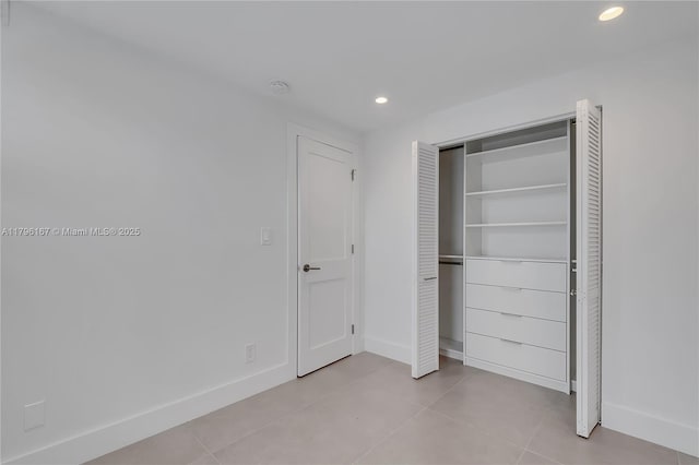 240 Galen Dr Unit 308, Key Biscayne, FL 33149 - unfurnished bedroom featuring a closet, light tile patterned floors, baseboards, and recessed lighting