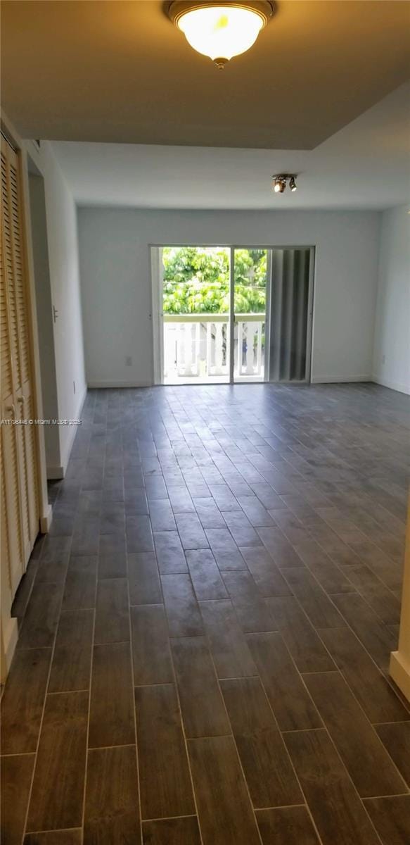 15205 NE 6th Ave Unit D204, Miami, FL 33162 - spare room with baseboards and dark wood finished floors