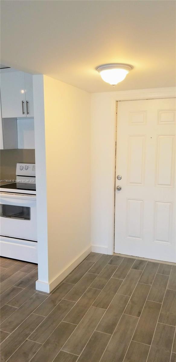 15205 NE 6th Ave Unit D204, Miami, FL 33162 - empty room featuring baseboards and wood tiled floor