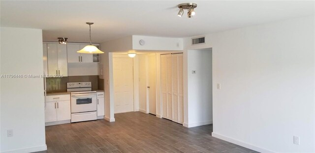 15205 NE 6th Ave Unit D204, Miami, FL 33162 - kitchen featuring dark wood-type flooring, white cabinets, white electric range, hanging light fixtures, and baseboards
