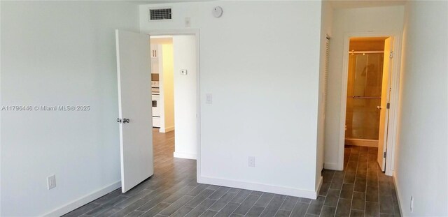15205 NE 6th Ave Unit D204, Miami, FL 33162 - unfurnished bedroom with visible vents, baseboards, and dark wood-style floors