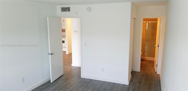 15205 NE 6th Ave Unit D204, Miami, FL 33162 - unfurnished bedroom featuring baseboards, visible vents, and dark wood finished floors
