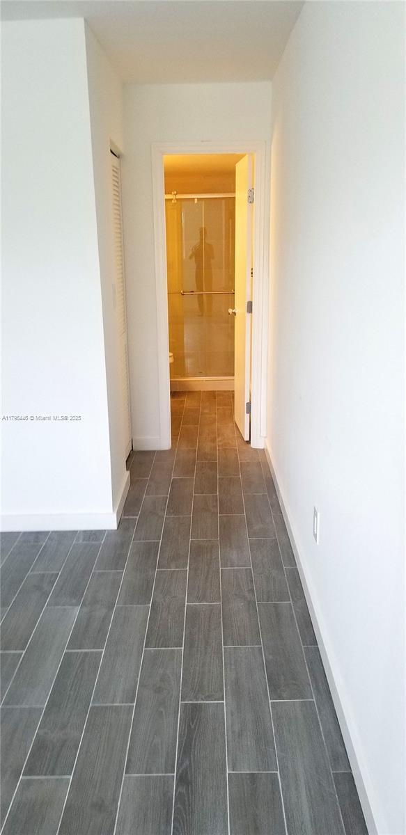 15205 NE 6th Ave Unit D204, Miami, FL 33162 - hall featuring wood finish floors and baseboards