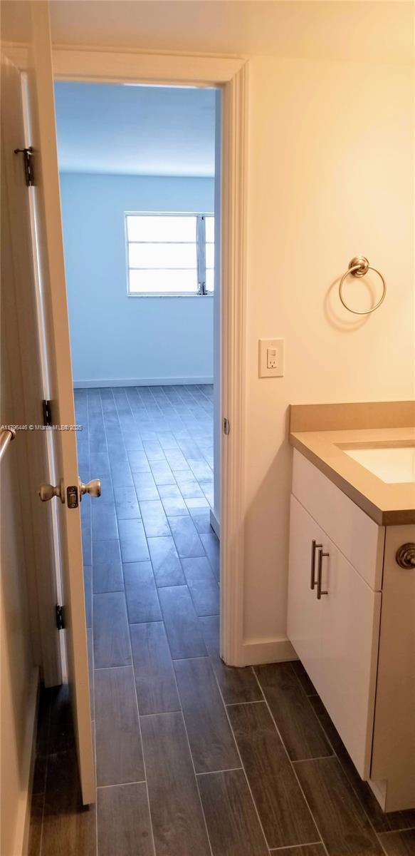 15205 NE 6th Ave Unit D204, Miami, FL 33162 - bathroom with vanity and wood finish floors