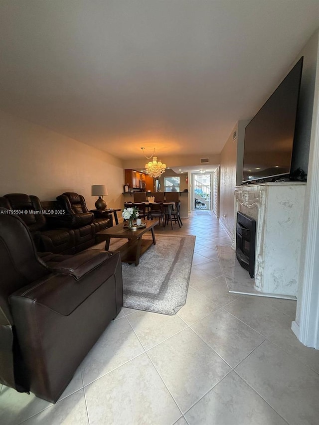 550 NW 78th Ter Unit 107, Margate, FL 33063 - living room with a fireplace, light tile patterned flooring, and a notable chandelier