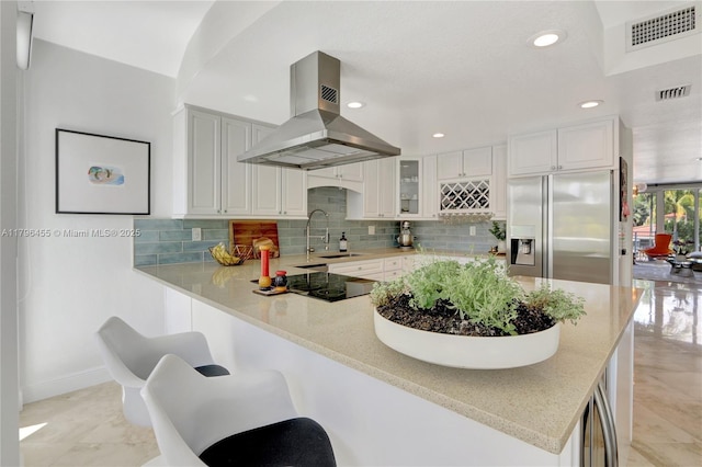 429 Hendricks Isle, Fort Lauderdale, FL 33301 - kitchen with stainless steel refrigerator with ice dispenser, island exhaust hood, a sink, black electric cooktop, and a peninsula