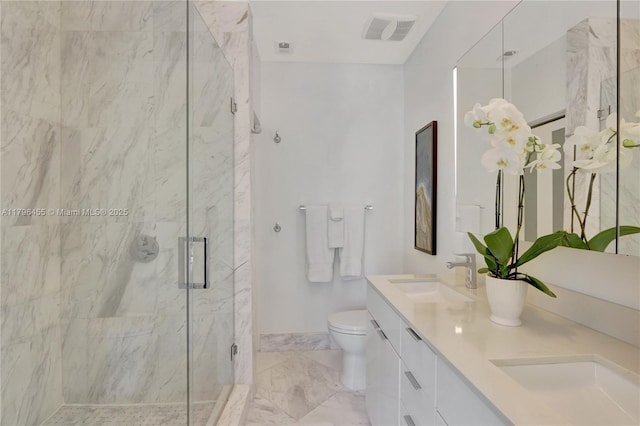 429 Hendricks Isle, Fort Lauderdale, FL 33301 - bathroom featuring a marble finish shower, toilet, double vanity, and marble finish floors
