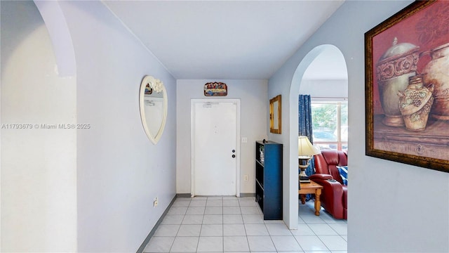 18231 SW 90th Ct, Palmetto Bay, FL 33157 - hall with arched walkways, baseboards, and light tile patterned floors