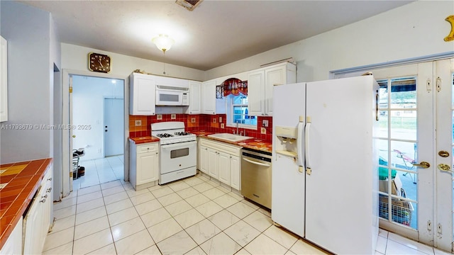 18231 SW 90th Ct, Palmetto Bay, FL 33157 - kitchen with a sink, white appliances, white cabinets, and tasteful backsplash