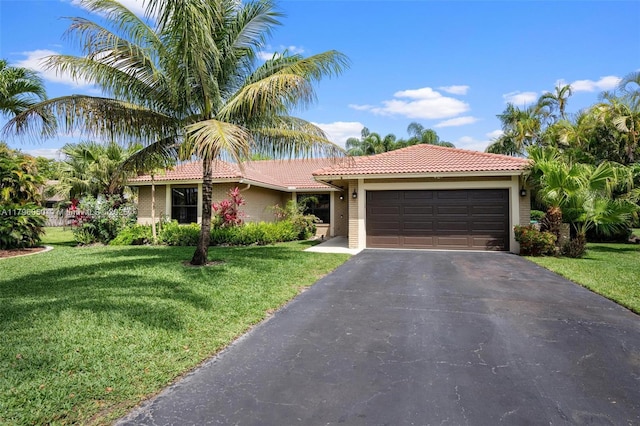 11377 NW 21st Ct, Coral Springs, FL 33071 - view of front facade with a tiled roof, an attached garage, and a front yard