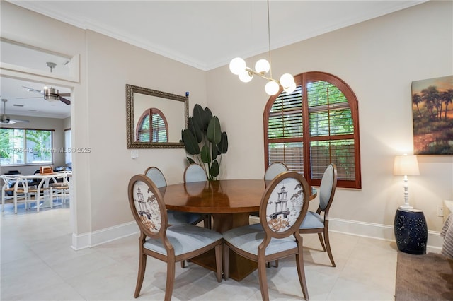 dining space featuring crown molding, light tile patterned flooring, baseboards, and ceiling fan with notable chandelier
