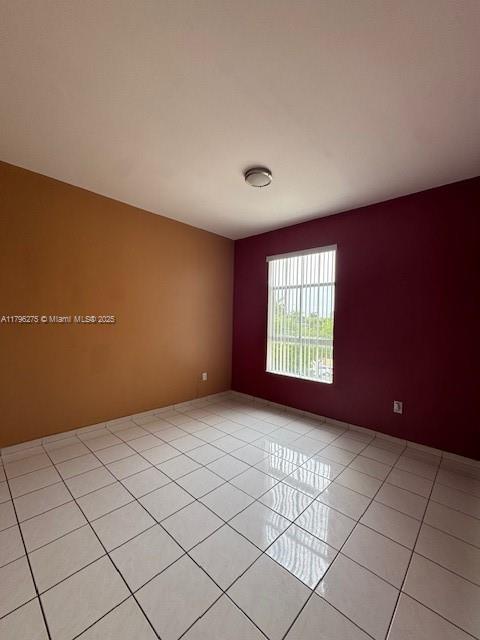 7400 W 20th Ave Unit 326, Hialeah, FL 33016 - empty room with light tile patterned flooring