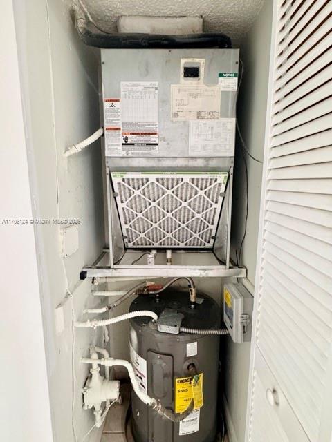 utility room with water heater