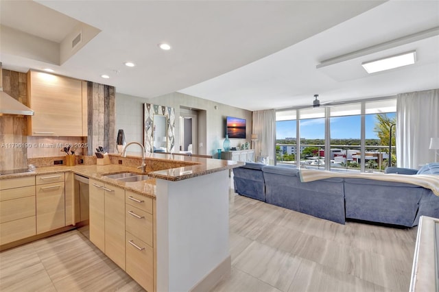 kitchen with a sink, open floor plan, light brown cabinetry, black electric cooktop, and modern cabinets
