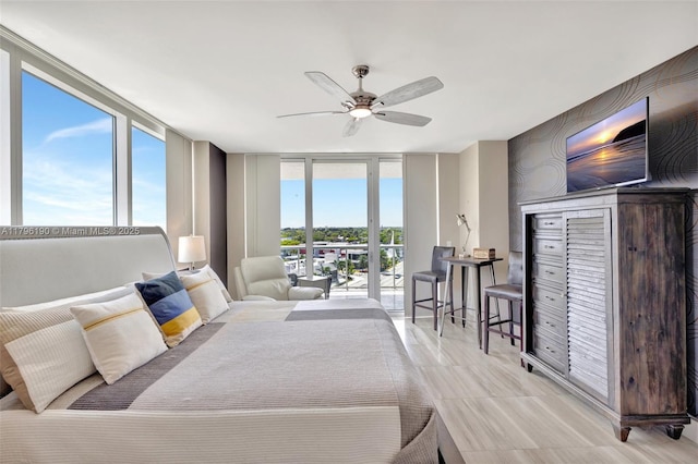 bedroom with a ceiling fan, a wall of windows, and access to exterior
