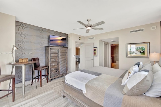 bedroom featuring ensuite bath and visible vents