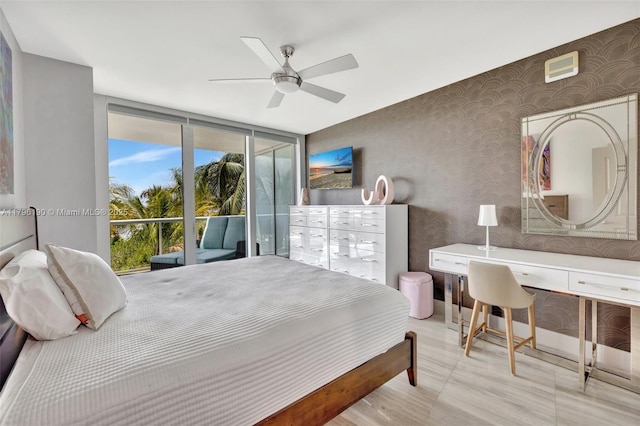 bedroom featuring wallpapered walls, floor to ceiling windows, access to outside, and a ceiling fan