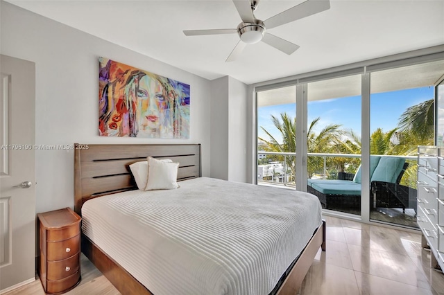 bedroom featuring ceiling fan, access to outside, and expansive windows