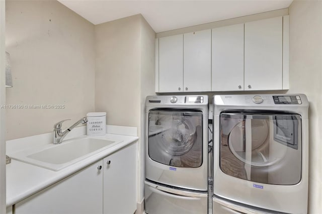 clothes washing area with cabinet space, washing machine and clothes dryer, and a sink