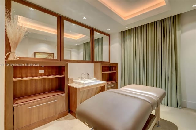 interior space with light carpet, a raised ceiling, and recessed lighting