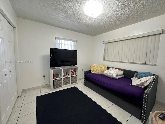 living room with tile patterned flooring and a textured ceiling