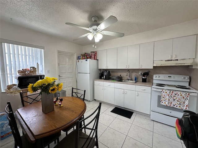 kitchen with a sink, white appliances, under cabinet range hood, light countertops, and a ceiling fan