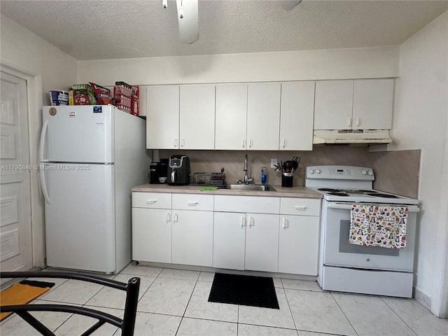 kitchen with a sink, white appliances, under cabinet range hood, white cabinetry, and light countertops