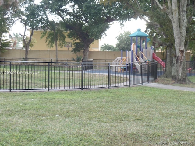 exterior space with fence and a lawn
