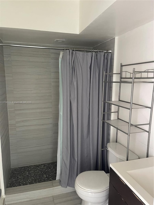 200 S Birch Rd Unit 1111, Fort Lauderdale, FL 33316 - bathroom featuring vanity, toilet, and a tile shower