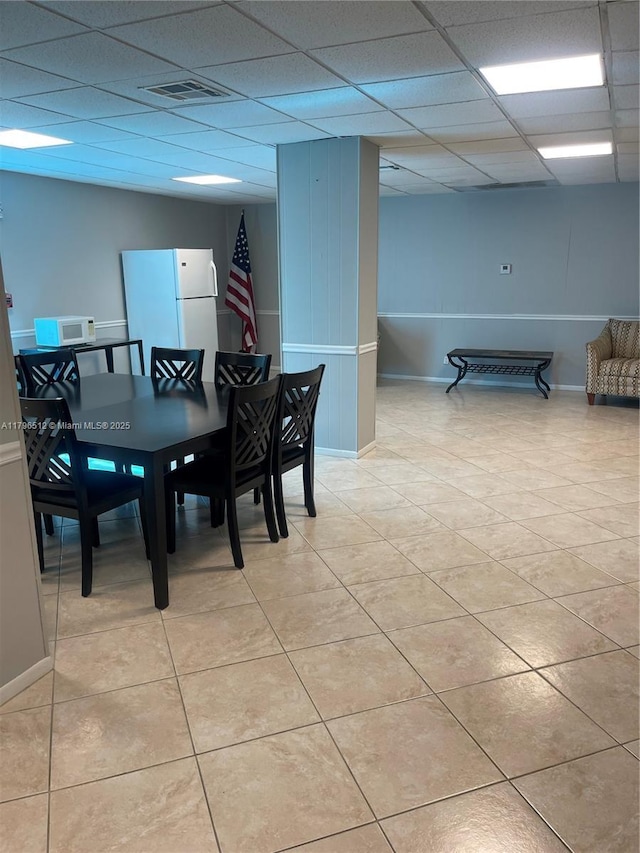 200 S Birch Rd Unit 1111, Fort Lauderdale, FL 33316 - dining space featuring a paneled ceiling, baseboards, and light tile patterned flooring