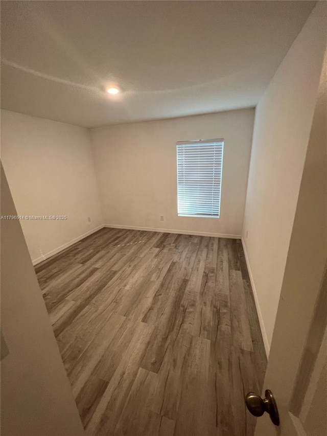 203 Palmwood Dr, Palm Coast, FL 32164 - unfurnished room featuring wood finished floors and baseboards