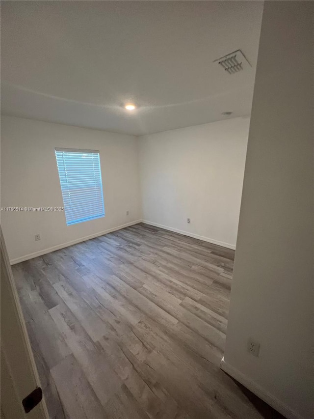 203 Palmwood Dr, Palm Coast, FL 32164 - unfurnished room with baseboards, visible vents, and wood finished floors